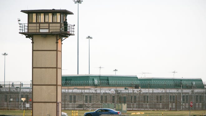 A prison guard stands at one of the towers at Vaughn Correctional Center after all Delaware prisons went on lockdown due to a hostage situation unfolding at the prison.