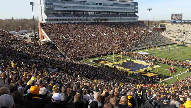 Fans watch as Iowa's Alex Meyer wrestles Oklahoma State's Kyle Crutchmer at 174 pounds during their dual at Kinnick Stadium on Saturday, Nov. 14, 2015.