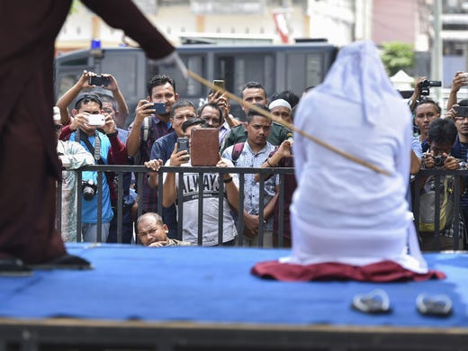 An Indonesian woman is whipped in public in Banda Aceh