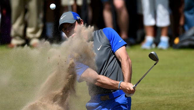 Rory McIlroy of Northern Ireland hits from a bunker on the 16th hole Thursday in the first round of the British Open.