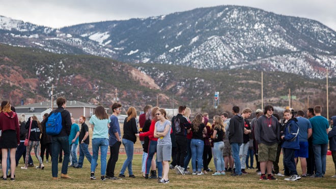 Cedar High School students gather on the football field March 14, 2018, during the ENOUGH: National School Walkout to protest gun violence in schools.