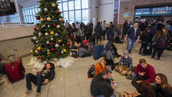 Passengers affected by a widespread power outage wait