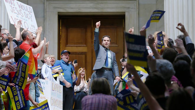 Rep. Warwick Sabin, D-Little Rock, center, cheers with protesters outside of the House chamber at the Arkansas state Capitol in Little Rock, Ark., Monday.