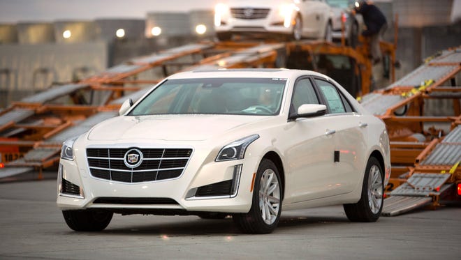 2014 Cadillac CTS sedans are loaded onto car carriers for delivery at the General Motors Lansing Grand River Assembly Plant at dawn Friday, November 1, 2013, in Lansing, Michigan.