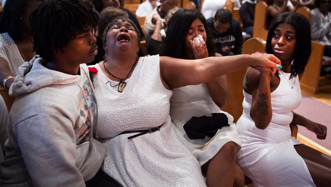 Johnny Ray Johnson's mother, Lentory Johnson, is supported by Kilo Parker, Samaria Hossain, and MarKisha Chess as she cries out during a song at a celebration of life service for her son at Ebenezer Baptist Church on Thursday.