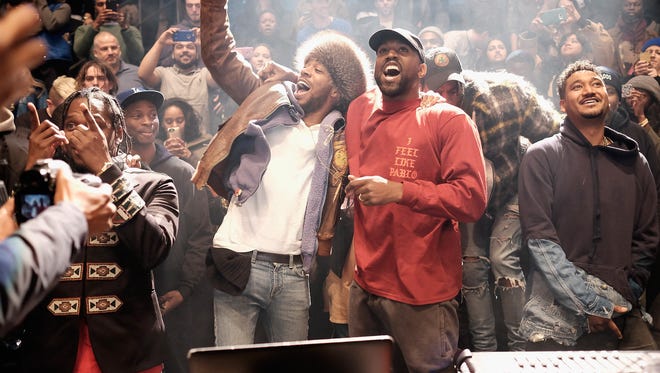 Kid Cudi, left, and Kanye West during the "Yeezy Season 3" album launch and fashion show at Madison Square Garden in New York Thursday.