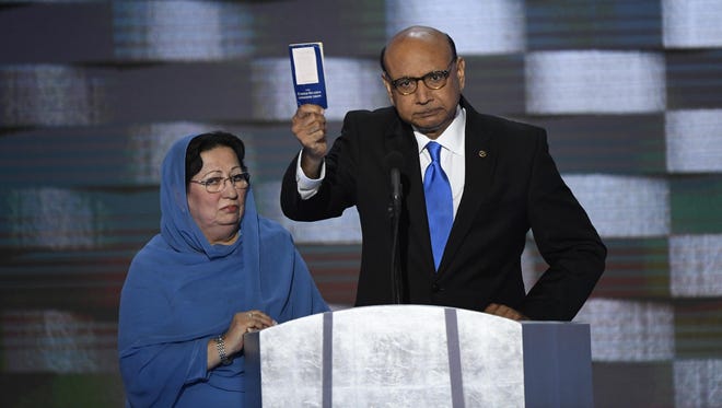 Khizr Khan, father of fallen U.S. soldier Humayun S.M. Khan, offers a copy of The Constitution to Donald Trump as he speaks during the 2016 Democratic National Convention at Wells Fargo Center.