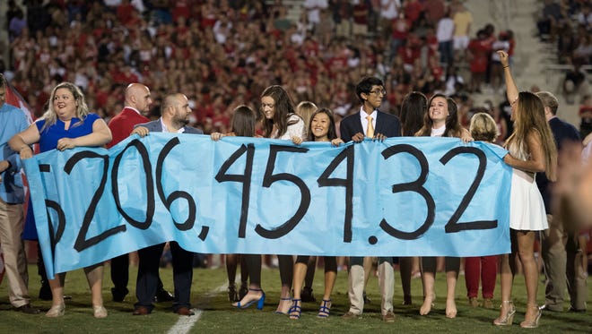 J.L. Mann students unveil how much money they raised for charity during a game at Sirrine Stadium on Friday, September 15, 2017. 