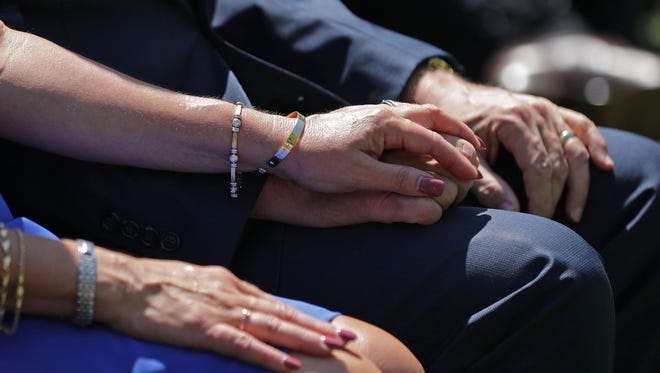 Vice President Mike Pence holds hands with his wife Karen during an event to mark the National Day of Prayer at the White House on May 3, 2018 in Washington. 