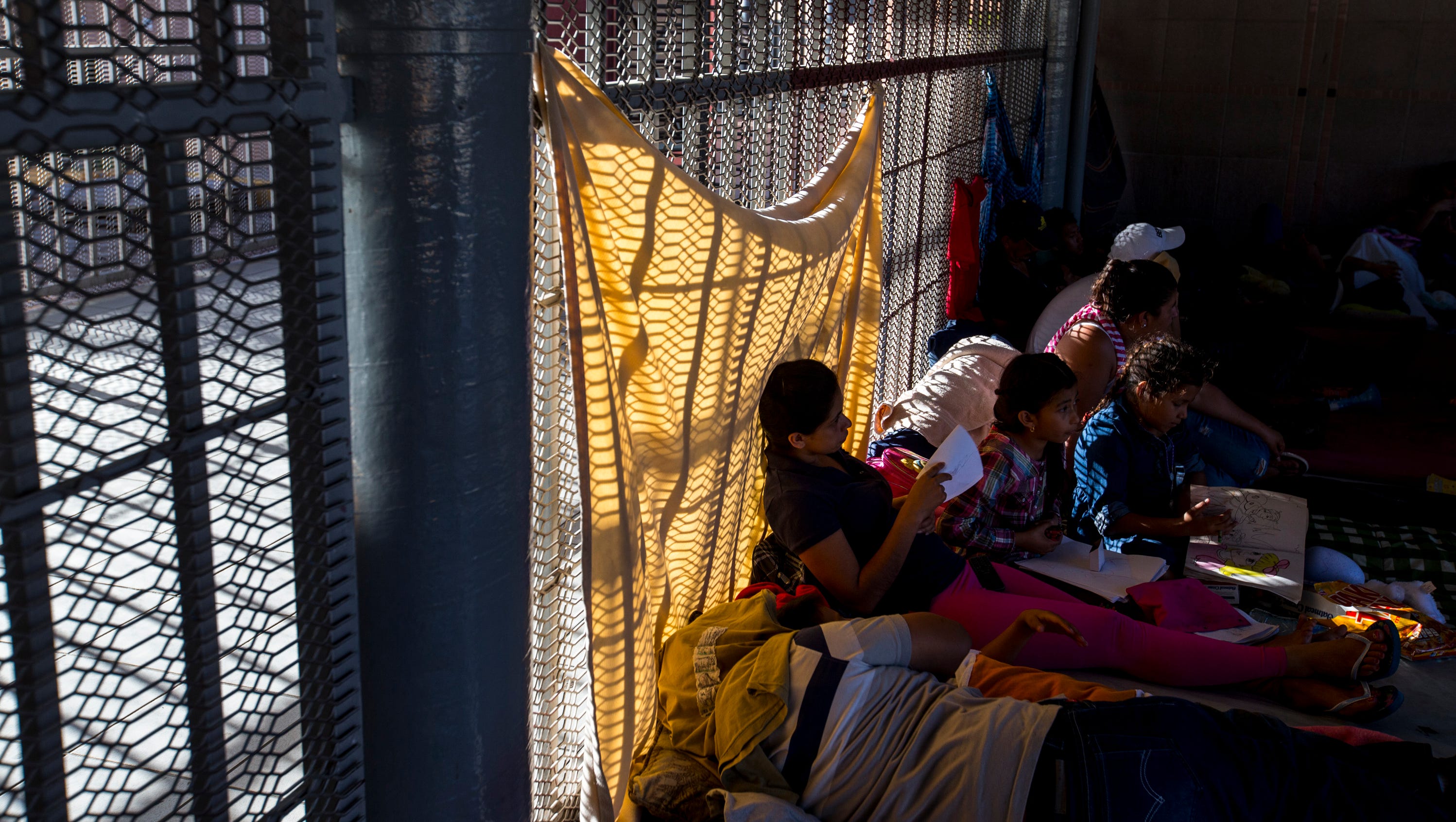 Immigrants seeking asylum status wait to be called