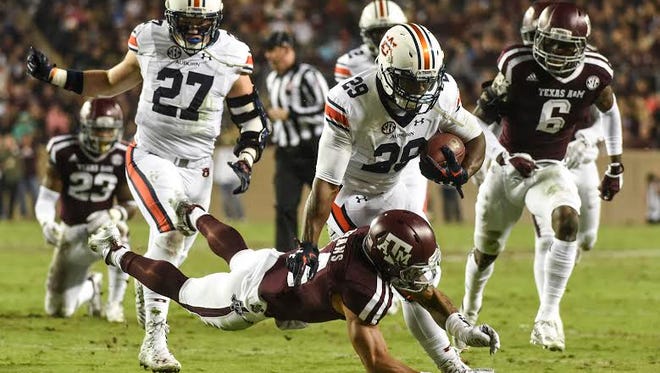 Jovon Robinson (29) pushes a defender off of him. 
Auburn at Texas A&M in College Station, Texas. on Saturday, Nov. 7, 2015.