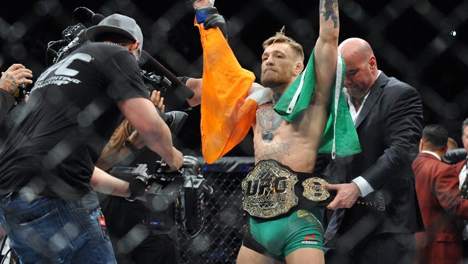Conor McGregor is declared the winner by knockout and crowned champion during UFC 194 at MGM Grand Garden Arena.