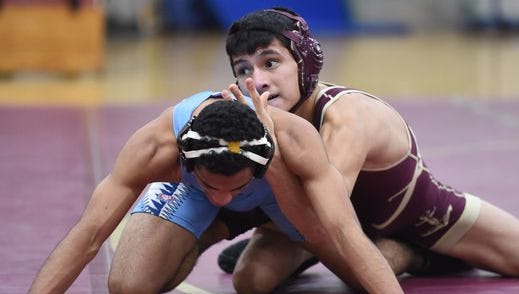 Action from Wednesday's wrestling tournament between John Jay and Arlington.