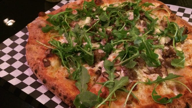 The Fun Guy (topped with portabello mushrooms, house blend cheese, goat cheese on top of a white sauce and finished with arugula drizzled with white truffle oil) is the best seller at Broken Tree Pizza in Neenah.