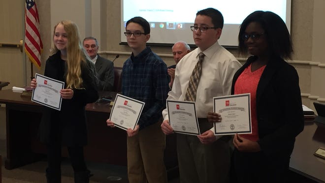 Four Rutherford County Schools students were honored for perfect scores on last year's TCAP writing assessment during a school board meeting Thursday. The students are, from left, Keiko Terry, Grant Tiller, Peyton Turney and Thelma Yankey.
