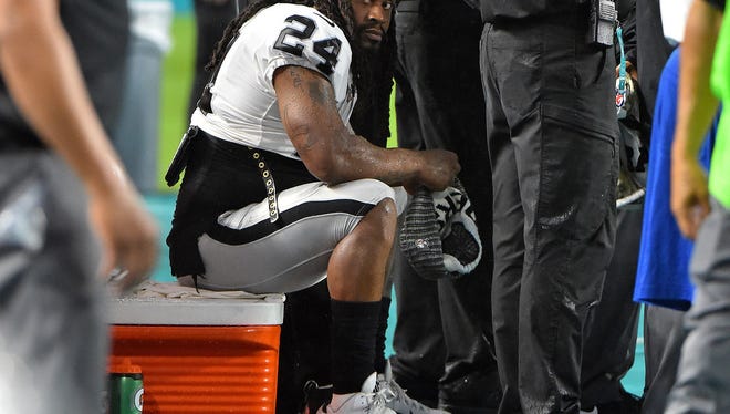 Oakland Raiders running back Marshawn Lynch  sits on a cooler during the National Anthem prior to a game against the Miami . Columnist Joe Phalon is not sure about the NFL players' protest.