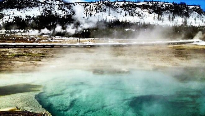 Sapphire Geyser at Biscuit Basin in Yellowstone National Park. Yellowstone is among popular national parks that will boost fees by $5, up from the current $30 but far below the figure Interior proposed last fall.