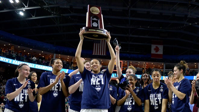Connecticut's Saniya Chong holds the trophy as she poses with her teammates following their 90-52 win over Oregon in a regional final game in the NCAA women's college basketball tournament, Monday, March 27, 2017, in Bridgeport, Conn.