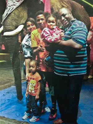 In this undated family file photo provided by the National Action Network, Eric Garner, right, poses with his children during a family outing. According to a lawyer for the victim’s family, a New York City grand jury on Wednesday cleared a white police officer in the videotaped chokehold death of the unarmed Garner, who had been stopped on suspicion of selling loose, untaxed cigarettes.
