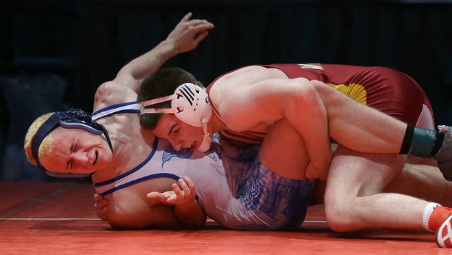 Mater Dei's Joe Lee,right, takes down Perry Meridian's Noah Warren,left, 19-5 to win the 152-pound championship match at the IHSAA Wrestling State Finals on Saturday. Lee won the 145-pound title last year.