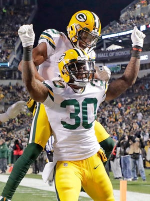 Green Bay Packers running back Jamaal Williams (30) celebrates his long touchdown run against the Pittsburgh Steelers at Heinz Field Sunday, November 26, 2017 in Pittsburgh, PA.