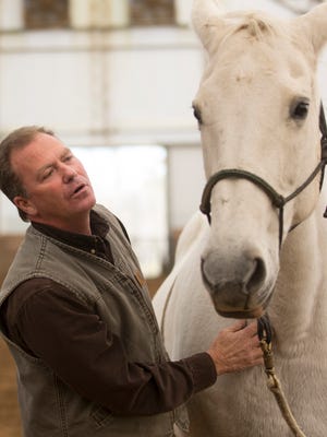 Greg Kallmeyer talks to Vienna, a "sensitive" mare that he trains at the Kallmeyer Equestrian Center.