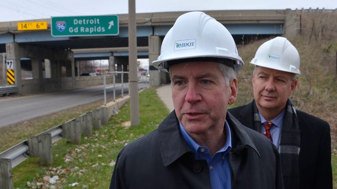 Michigan Governor Rick Snyder and roads chief Kirk Steudle inspect a bridge on I-96 at Cedar St. in Lansing on Friday to highlight the need for additional funding for road repair in the state.
