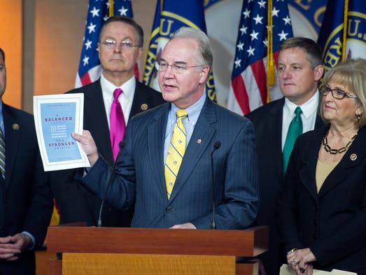 Price holds up a synopsis of the House Republican budget