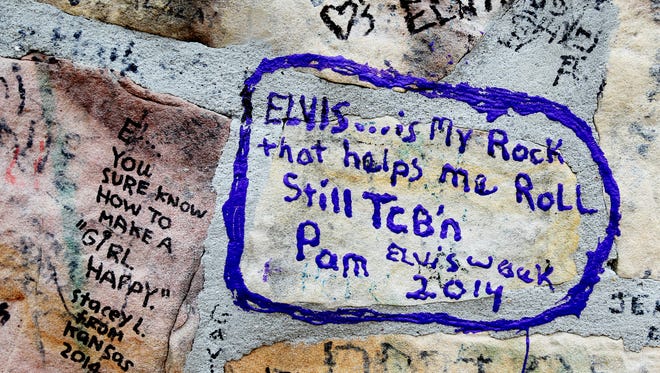 Graffiti left by Elvis Presley fans adorn the wall outside Graceland on May 14, 2015.