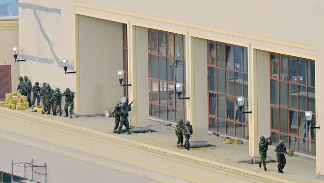 Kenyan soldiers move in formation, clearing the top floor balcony and interior of Westgate Mall on Tuesday in Nairobi. Kenyan Defence troops remain inside the Westgate mall, in a standoff with Somali militants after they laid siege to the shopping centre shooting and throwing grenades as they entered. AFP PHOTO/Carl de SouzaCARL DE SOUZA/AFP/Getty Images ORG XMIT: - ORIG FILE ID: 523202748