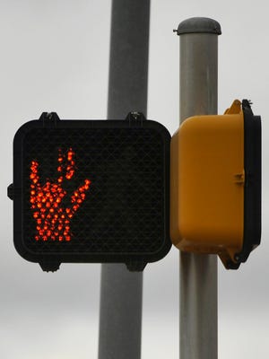 This "do not walk" sign on at Catclaw and Southwest drives had lost a few of its fingers when I saw it Dec. 29, suggesting the more subversive rock 'n' roll "Devil Horns" hand gesture.