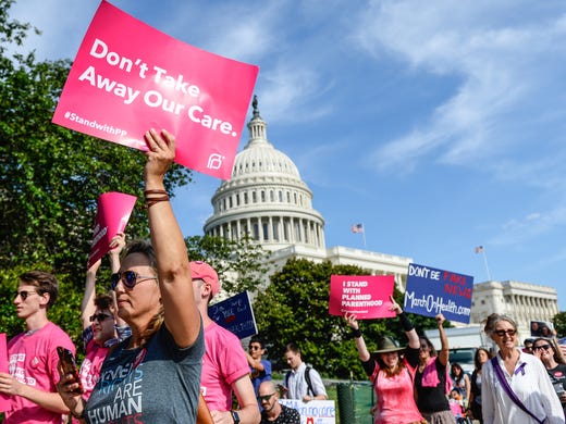 Protesters march around the U.S. Capitol to show their