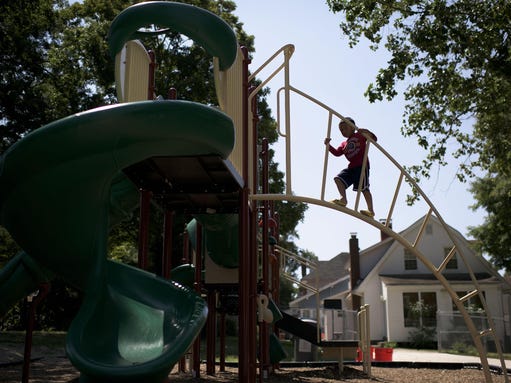 Eric Rodriguez, 5, climbs a jungle gym at Johnson Reeves