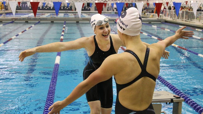Pittsford's Katie Smith shares a hug with Emma Corby after winning the 400 Yard Freestyle Relay. 