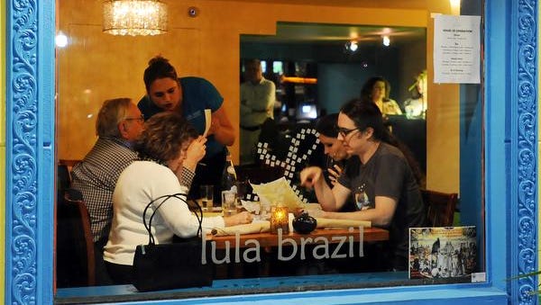 Diners enjoy dinner through the window at Lula Brazil a new restaurant that serves Brazilian inspired cuisine, which has opened at 234 Rehoboth Avenue in Rehoboth Beach.
