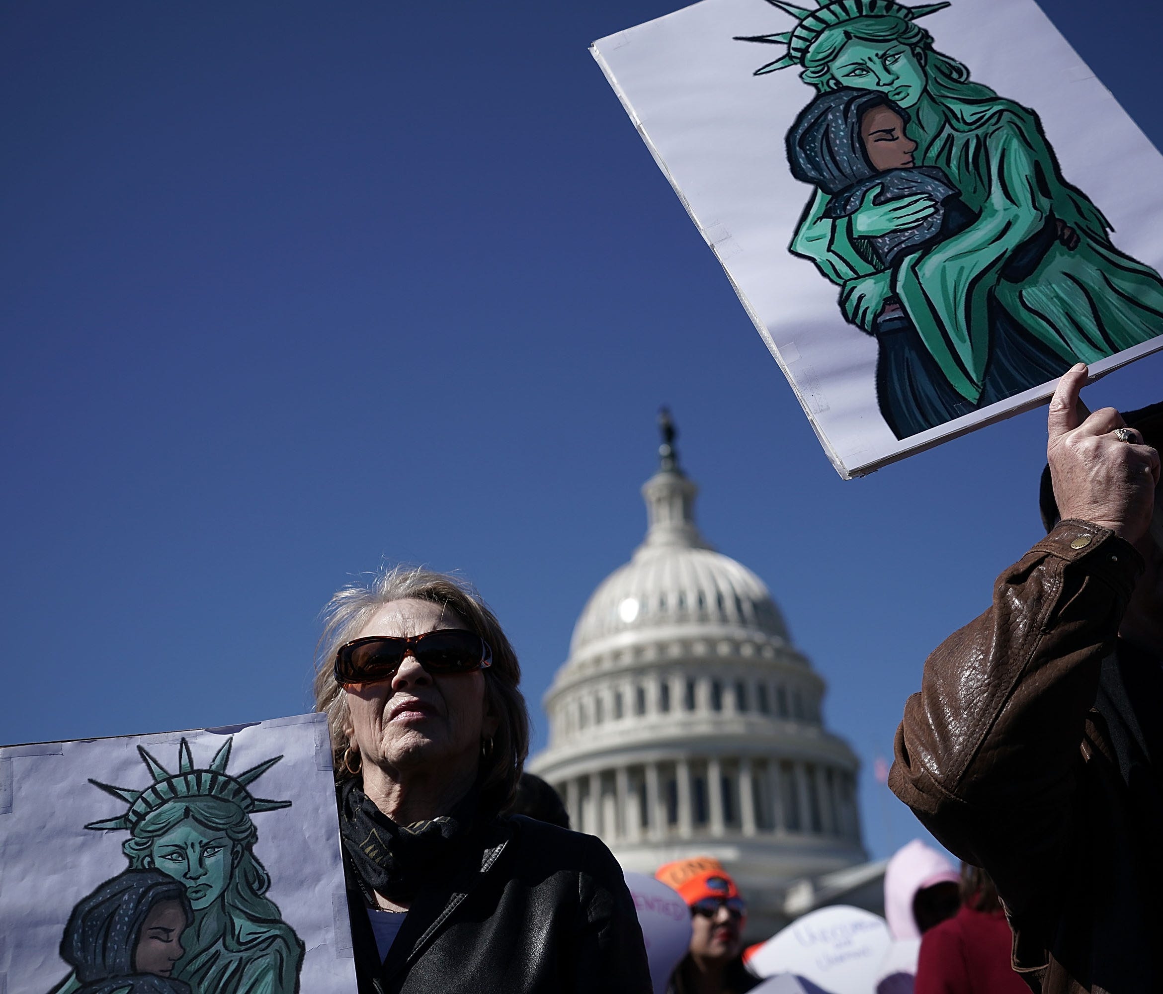 Immigration activists hold signs during a protest March 5, 2018 on Capitol Hill in Washington, D.C.