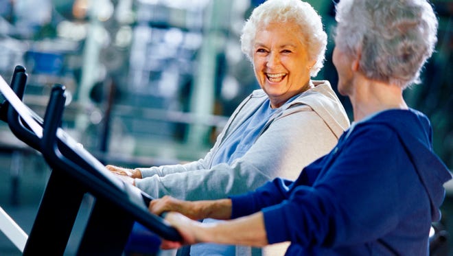 Two senior women exercising in a health club