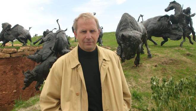 Actor Kevin Costner stands with bronze sculptures of bison and Native Americans at his Tatanka attraction in 2003 near Deadwood. The sculptures were commissioned for a resort he planned in the Black Hills that was never built.
