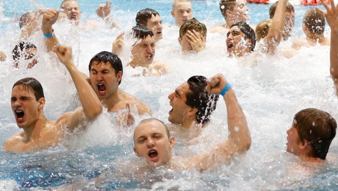 The Fossil Ridge mens swim team celebrate in the after winning the 5A State Championship, May 20 at the Veterans Memorial Aquatic Center in Thornton, CO. The Sabercats have won the state championship for the third year in a row.