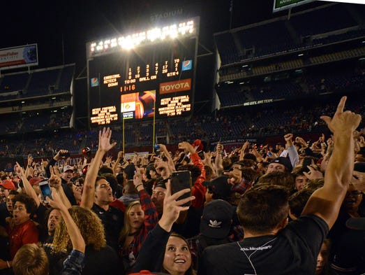 San Diego State Aztecs fans rush the field after the