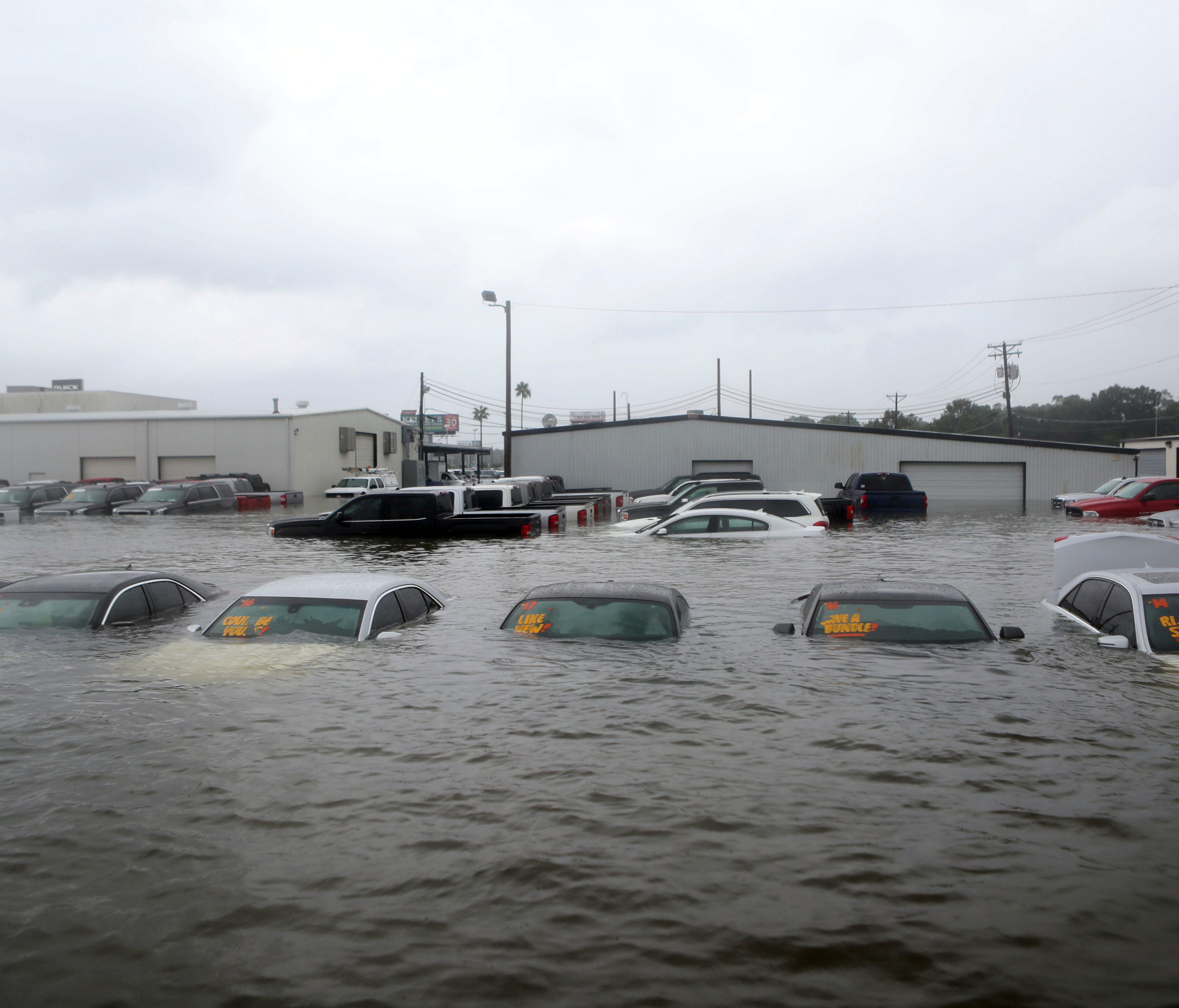 Vehicles are seen submerged at a dealership off Interstate 45 in Dickinson, Texas, on Aug. 27 as Hurricane Harvey ravaged the region.