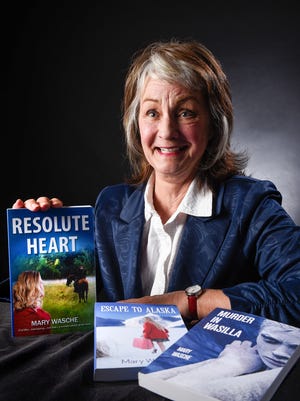 Author Mary Wasche, Isle, talks about her three books shown Monday, March 12.