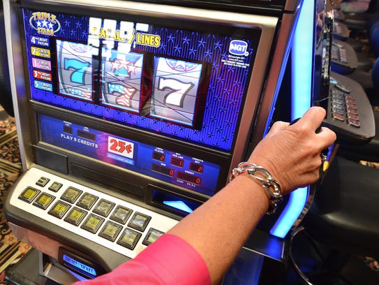 A customer plays a slot machine at the Casino at Ocean