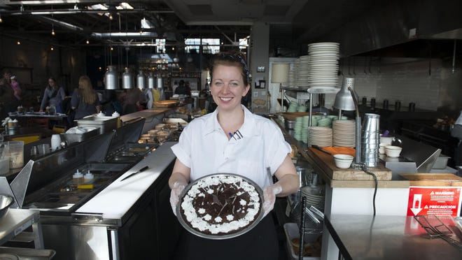 Baker/pastry chef Ashley Capps holds up a mint chocolate silk pie at the Buxton Hall restaurant at 32 Banks Ave. in Asheville.