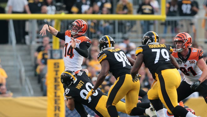 Cincinnati Bengals quarterback Andy Dalton (14) throws the ball out of bounds as he's pressured by Pittsburgh Steelers outside linebacker T.J. Watt (90) in the second quarter during the Week 7 NFL game between the Cincinnati Bengals and the Pittsburgh Steelers, Sunday, Oct. 22, 2017,  at Heinz Field in Pittsburgh. 