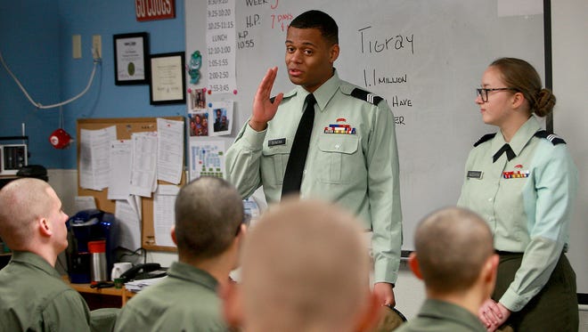 Former Washington Youth Academy cadets Damenique Duncan, 18, of Federal Way, and Daria Aleshina, 17, of Bremerton, answer questions from current cadets in Cal Glomstad's classroom while visiting the academy on Thursday.
