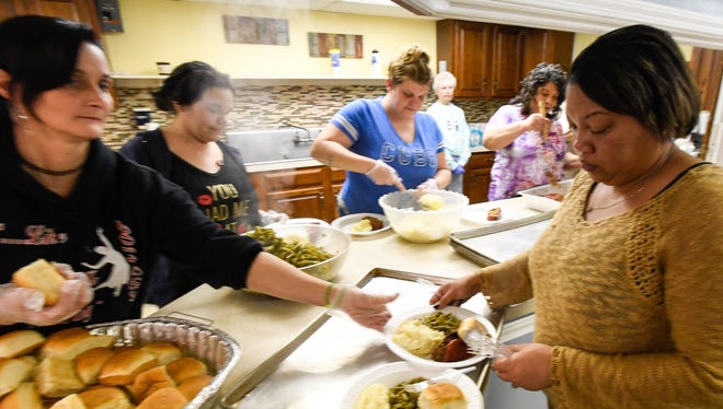 Volunteers (L-R) Wendy Harrison, Michelle Scoggins, Abbey Phillips, Kathy Holt and Tiffany Petrie put plates a hot food together for dinner at the East End Community Table Feeding Program held at Henderson's Bennett Memorial United Methodist Church Thursday. The program started by Larry and Kathy Holt has nearly tripled since it began in May of last year and needs more churches to come on board to help with the food, February 15, 2018.