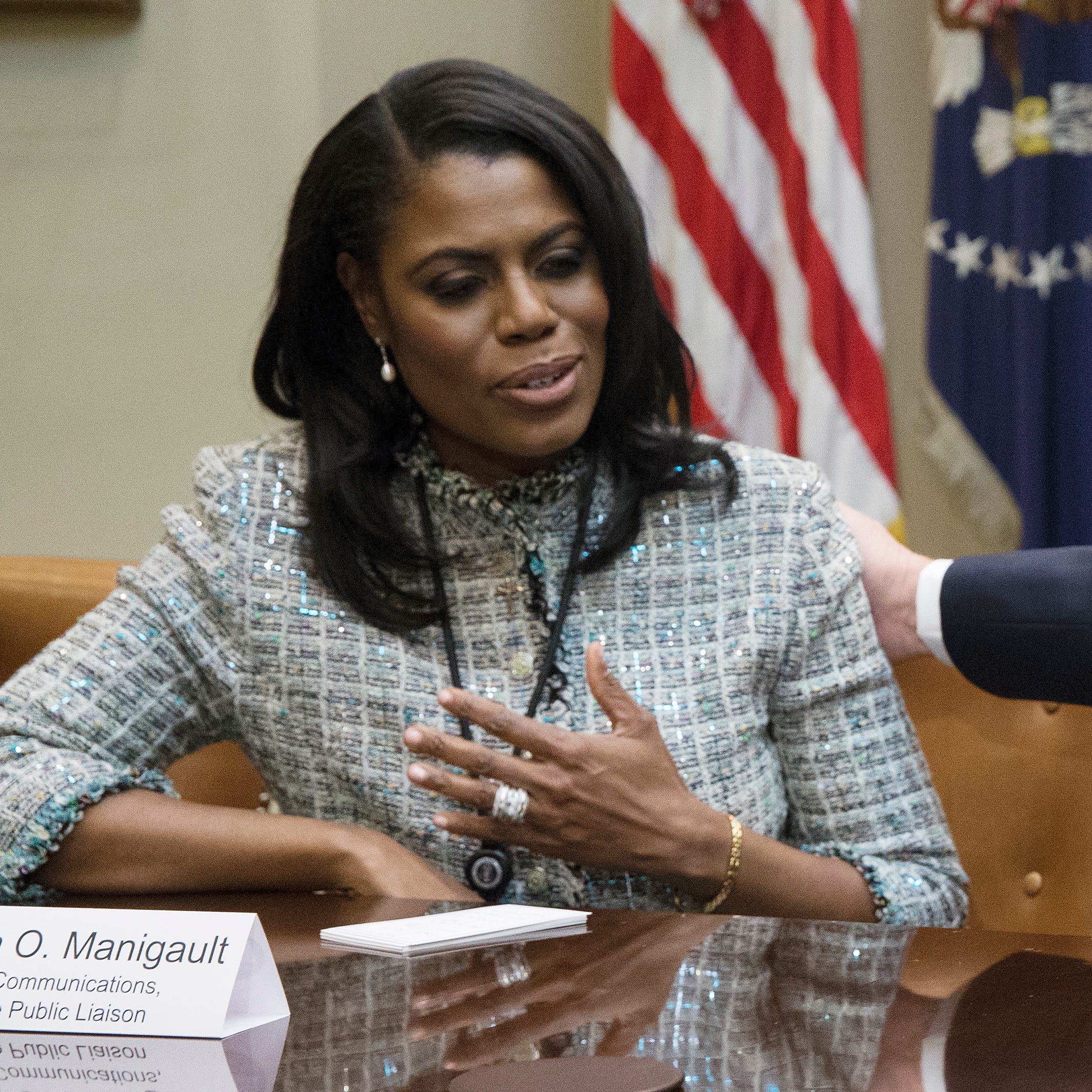 President Donald Trump speaks beside then Director of Communications for the Office of Public Liaison Omarosa Manigault-Newman.
