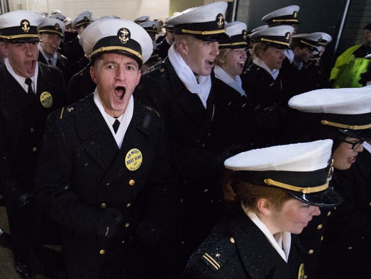 The Navy Midshipmen march onto the field before the