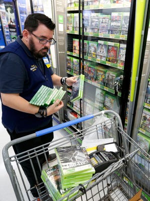 Scott Low stocks video games Tuesday in advance of the Black Friday shopping rush at the Windsor Heights Wal-Mart.